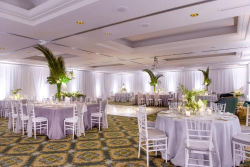 a banquet hall with white tables and chairs at The Cliffs Hotel and Spa in Pismo Beach