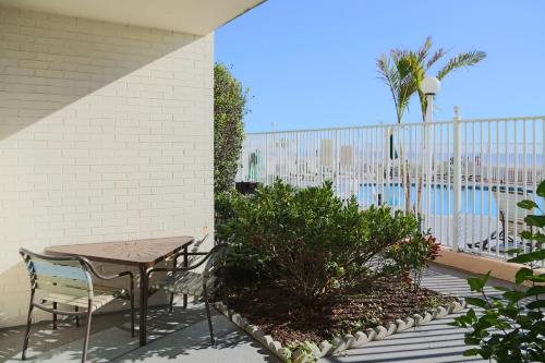 a patio with a table and chairs next to a pool at Quality Inn Boardwalk in Ocean City