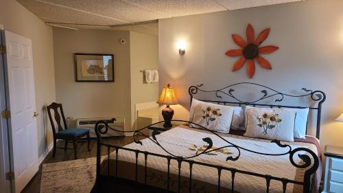 a bedroom with a bed and a table with a lamp at Gatlinburg Chateau Condo 506 in Gatlinburg