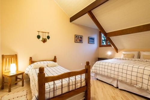 a bedroom with two beds in a attic at Apart Central MV in Monte Verde