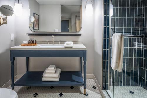 a bathroom with a sink and a shower at Jasper Hotel in Fargo