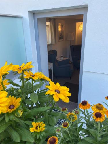 a bunch of yellow flowers in a living room at Pension Villa Ostseetraum in Warnemünde