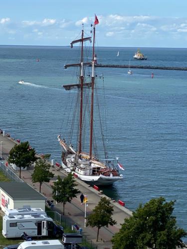 a boat sitting in the water next to a harbor at Pension Villa Ostseetraum in Warnemünde