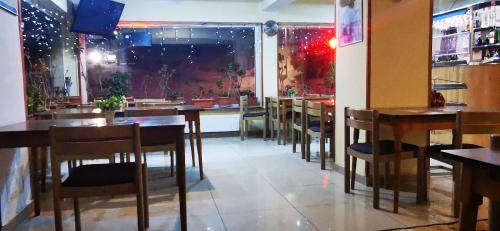 a dining room with tables and chairs in a restaurant at HOTEL ALL TIMES in Timisul de Jos