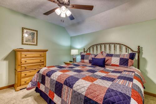 a bedroom with a bed and a ceiling fan at Brentwood, Resort Pool, FREE Attraction tickets, Near Parkway, Hot Tub, Arcade Game, WIFI!!! in Pigeon Forge