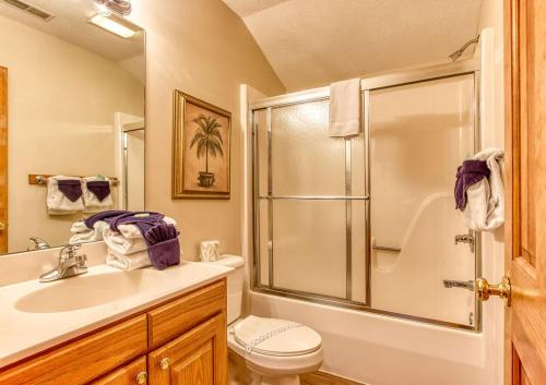 a bathroom with a shower and a sink and a toilet at Brentwood, Resort Pool, FREE Attraction tickets, Near Parkway, Hot Tub, Arcade Game, WIFI!!! in Pigeon Forge