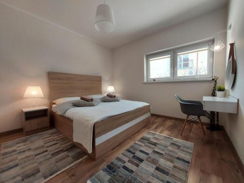 罗威Apartament Sun&Fun - Rowy的一间卧室，配有一张床、一张桌子和一把椅子