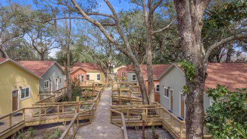 a group of houses with a path in the woods at Sea Cottages of Amelia in Fernandina Beach