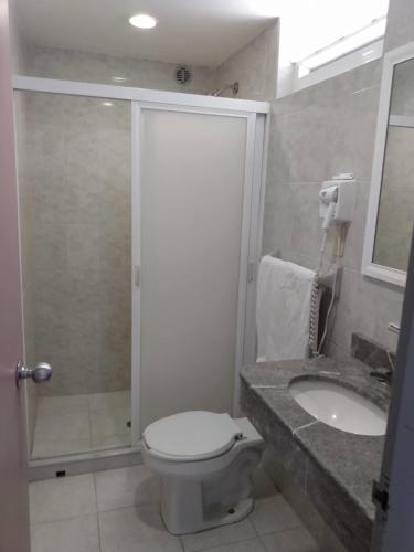 a bathroom with a shower and a toilet and a sink at Hotel Cuba in Mexico City
