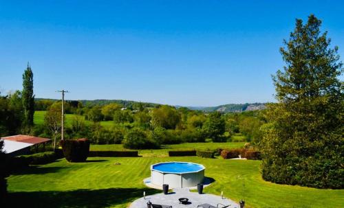 a picnic table in the middle of a grass field at Maison de vacances privative à louer in Aywaille