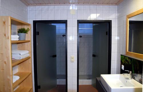 a bathroom with a shower and a sink at Alpenvereinshaus Pruggern in Pruggern