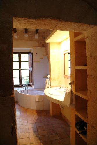 a bathroom with a tub and a sink at Son Baulo in Lloret de Vistalegre