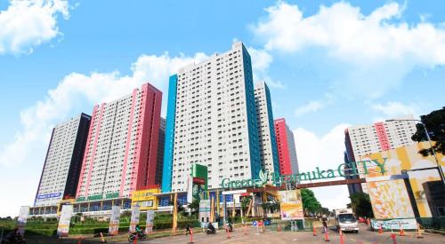 a group of tall buildings in a city at Properti9 at Apartemen Green Pramuka in Jakarta