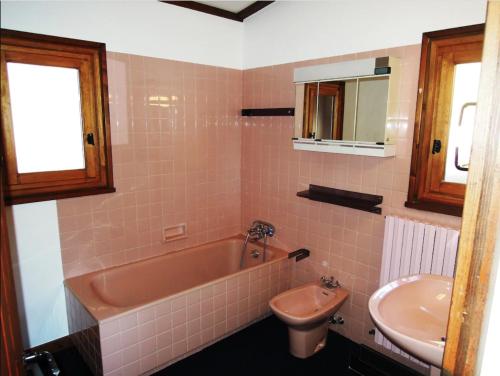 a bathroom with a tub and a toilet and a sink at Chalet familial à Megève, vue sur le village in Megève