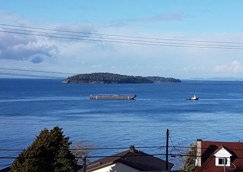 a large body of water with a boat in it at Blue Waters Cottage in Sechelt