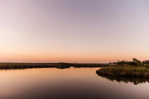 a view of a river at sunset at The Sanderling in Duck