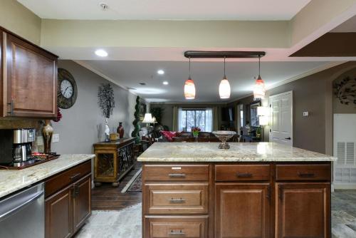 a kitchen with wooden cabinets and a counter top at Luxury Condos at Thousand Hills - Heart of Branson - Beautifully remodeled - Spacious and Affordable in Branson