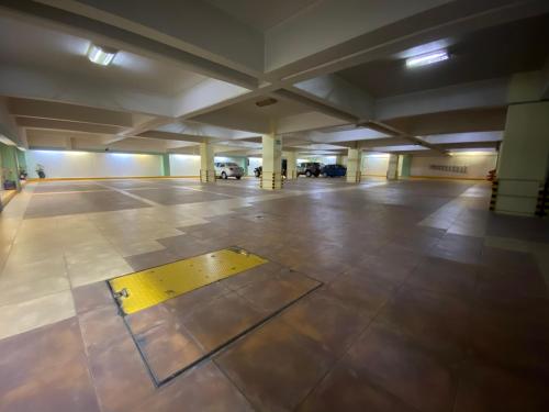 an empty parking lot with a yellow line on the floor at HOTEL MARIA RICO in Mexico City