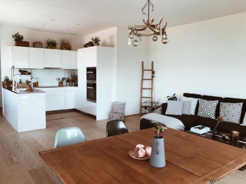 a kitchen and a living room with a dining room table at AVLiving City INSIDE NINE Basel in Basel