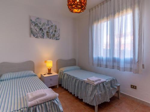 two twin beds in a room with a window at Villa in Albarella near Venice Beach in Isola Albarella