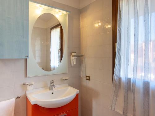 a bathroom with a sink and a mirror at Villa in Albarella near Venice Beach in Isola Albarella