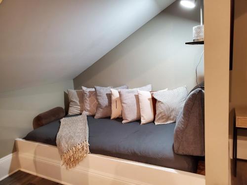 a couch with pillows on it in a room at Anchor Inn Boutique Hotel in Put-in-Bay
