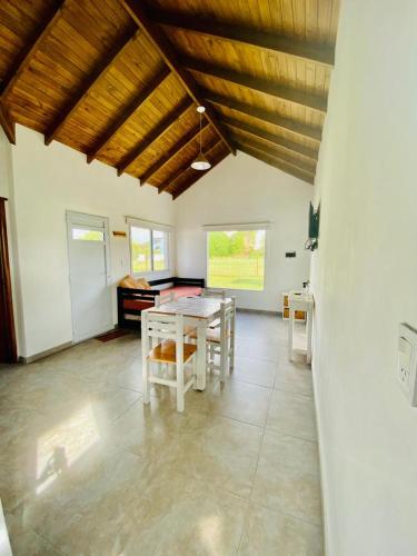 a large room with a table and chairs in it at Cabañas Mangata in Mar de Cobo
