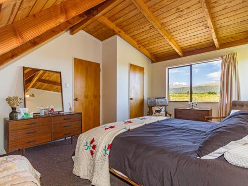a bedroom with a large bed and a large window at Mike 'n' Marion's - National Park Holiday Home in National Park