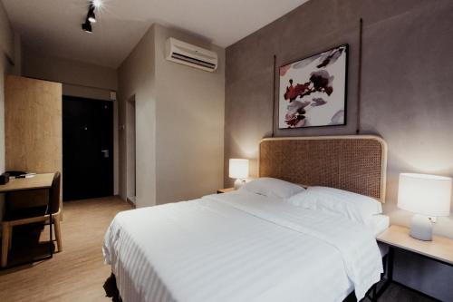 a bedroom with a large white bed and two lamps at Urban Living Residence in Kuala Lumpur