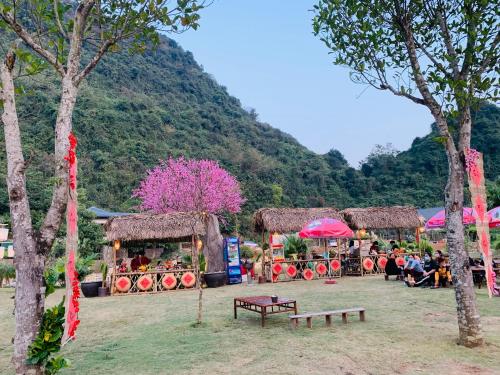 a group of people sitting around a park with a train at Tuan Nam Homestay in Ninh Binh