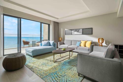 a living room with a couch and a table at Crowne Plaza Phu Quoc Starbay by IHG in Phu Quoc