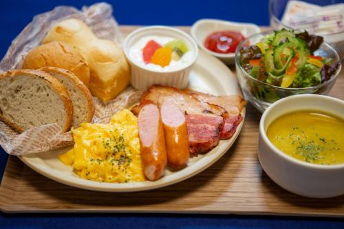 a plate of breakfast food with eggs sausage bread and toast at Blue Cove Terrace in Miyako Island
