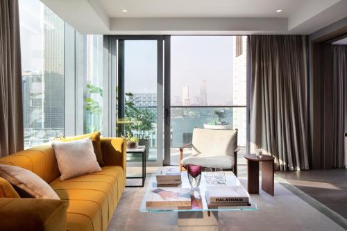 a living room filled with furniture and a window at The Hari Hong Kong in Hong Kong