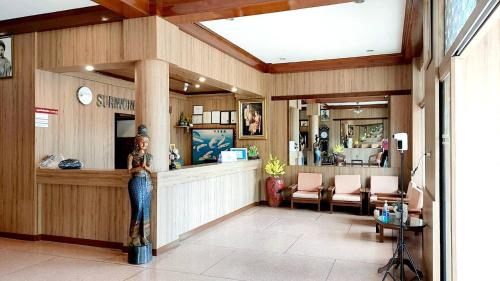 a lobby of a store with a counter and chairs at Suriwong Chumphon Hotel in Chumphon