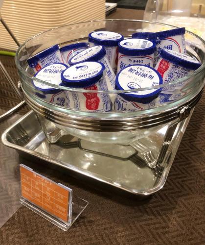 a glass container filled with packets of food on a table at le Lac HOTEL Otsu Ishiyama in Otsu