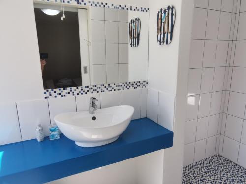 a bathroom with a white sink and a mirror at Langebaan Paradise Beach Self Catering 5 Elara in Langebaan