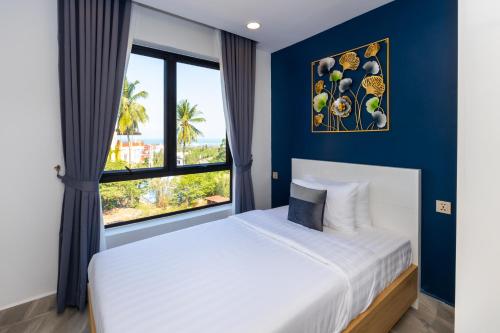 a bedroom with a large bed and a large window at SS Hotel & Residence in Sihanoukville
