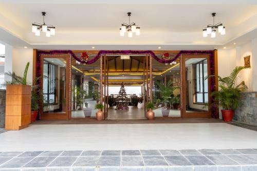 an open lobby with a christmas tree in the center at Mountain Glory Forest Resort in Pokhara