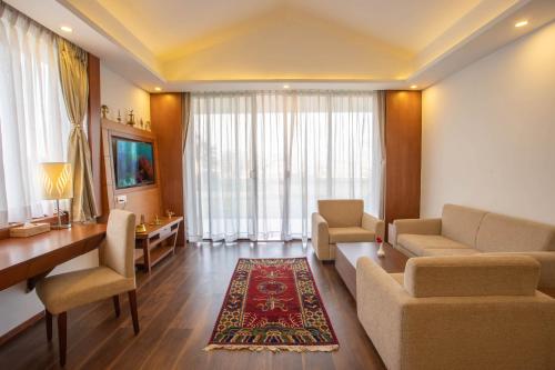a living room with a couch and chairs and a table at Mountain Glory Forest Resort in Pokhara