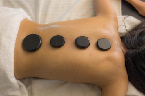 a woman laying on a bed with black circles on her back at Mountain Glory Forest Resort in Pokhara