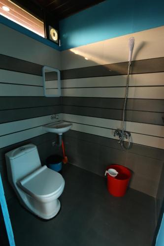 a bathroom with a toilet and a sink at Spice Valley Home Stay & Tree House Munnar in Munnar
