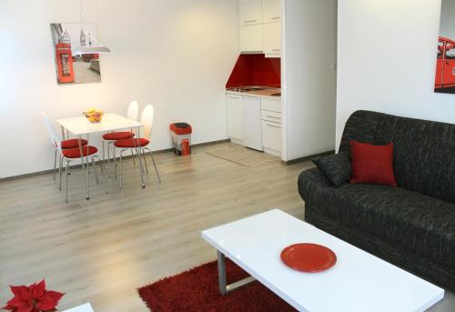 a living room with a couch and a table at Modern City Apartments in Sarajevo
