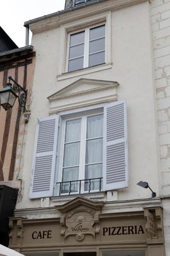 a white building with white shuttered windows on it at Villa Roma B&B in Amboise