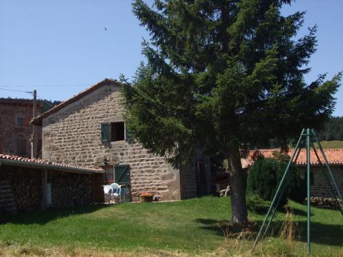 a stone house with a tree in front of it at Beautiful holiday home with mountain view in Sauvain