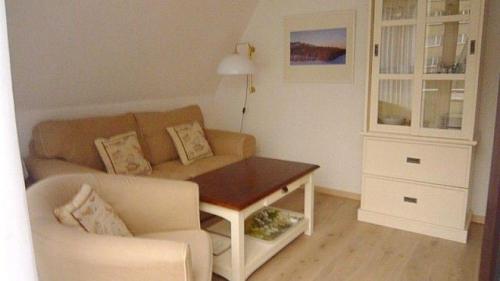 sala de estar con sofá y mesa en Sylter-Besserburg-App-14, en Westerland