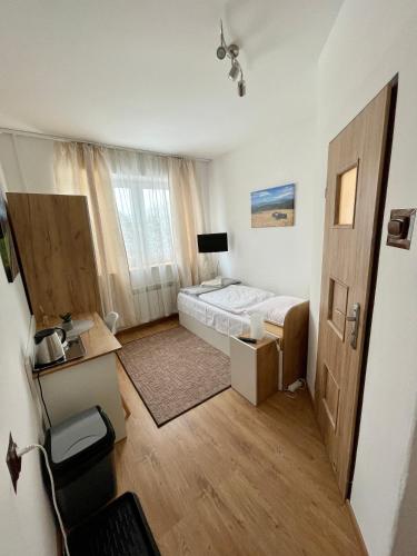 a small room with a bed and a window at Dom Wczasowy Anna in Rabka-Zdrój