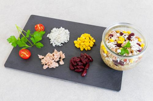 a cutting board with rice and a bowl of food at Comfort Aparthotel Cannes Mandelieu in Mandelieu-la-Napoule