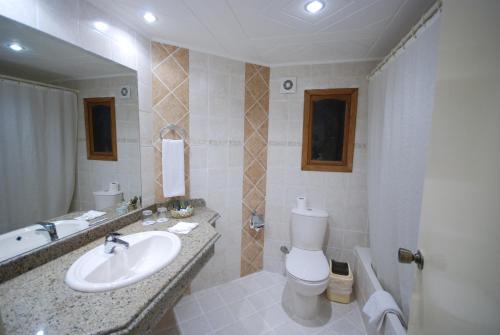 a bathroom with a sink and a toilet and a tub at Coral Hills Resort Sharm El-Sheikh in Sharm El Sheikh
