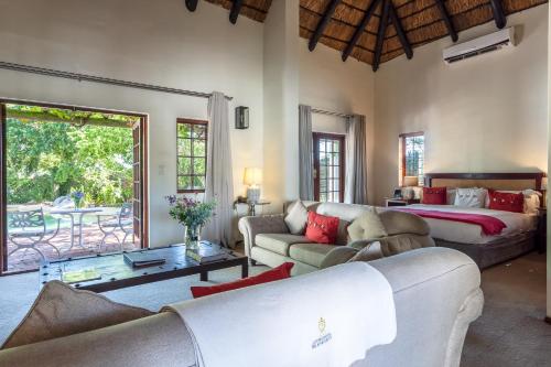 a living room with a couch and a bed at Wedgeview Country House & Spa in Stellenbosch