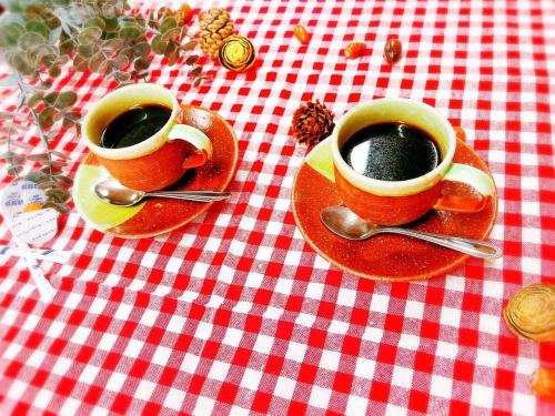 two cups of coffee sitting on a red and white table at Yamanaka Lake Ryozan in Yamanakako